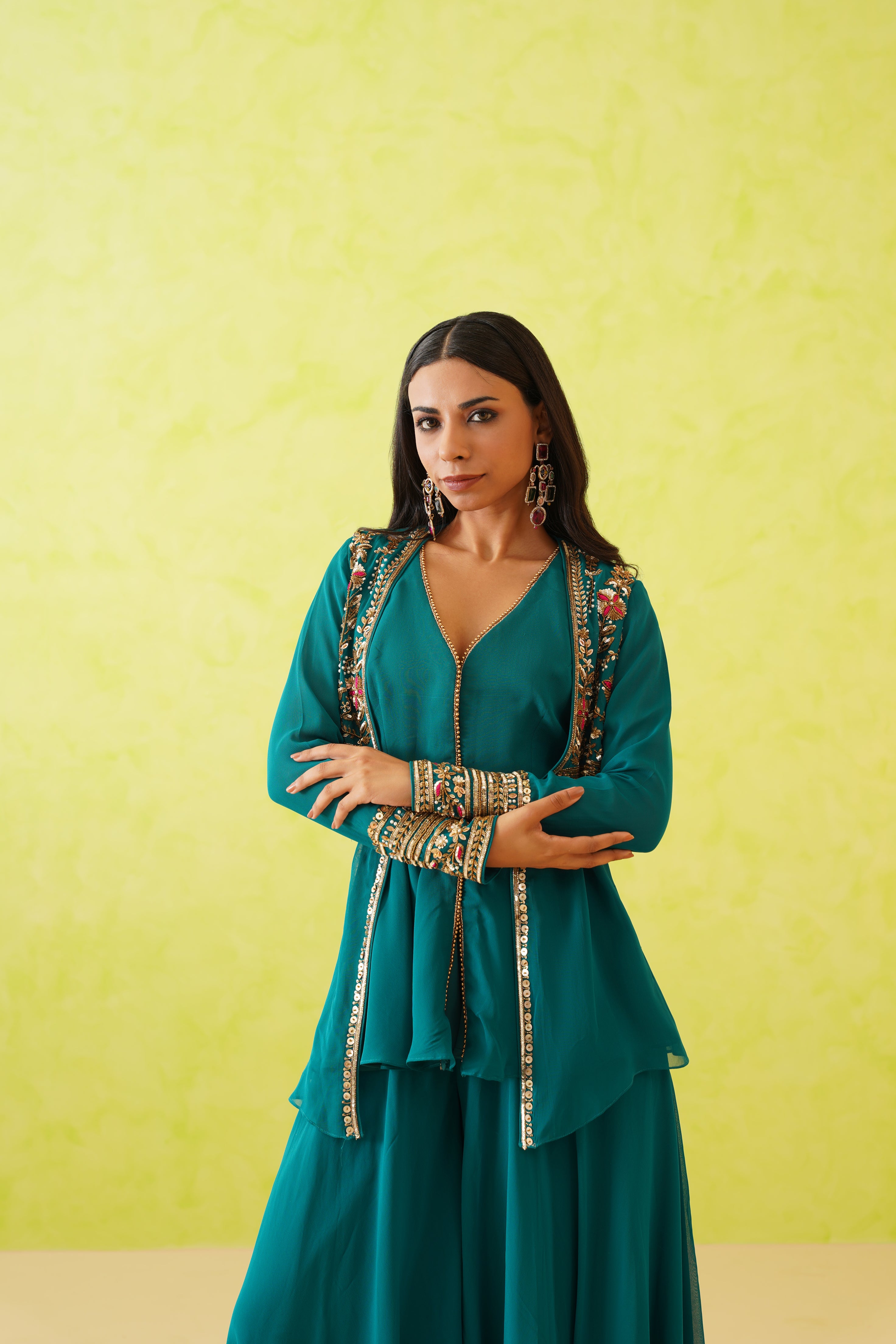 Dazzle in Deepika Chadha's green set, adorned with intricate crystal, stone, and resham embroidery.