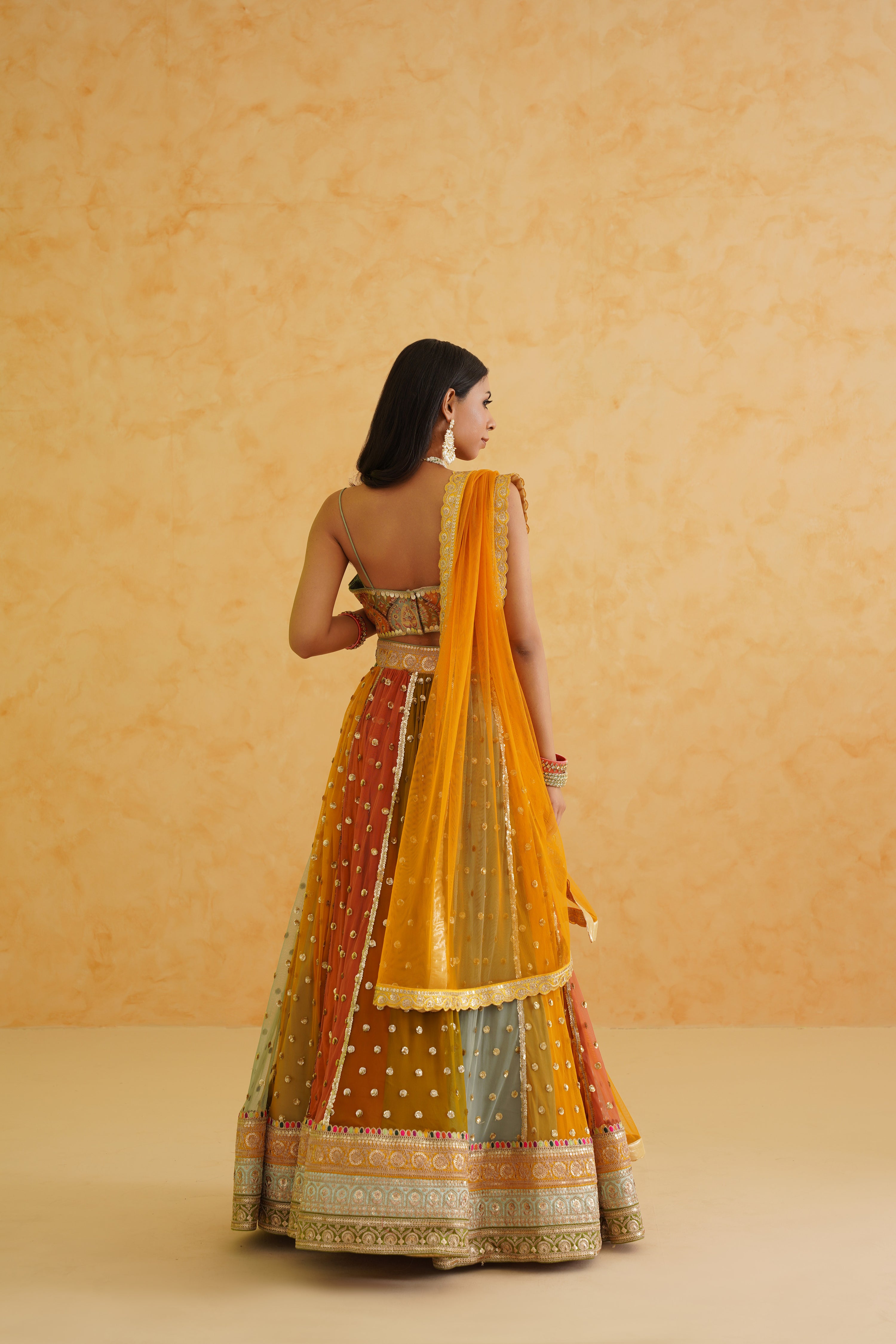 Stunning multi-colored lehenga featuring intricate net texture, designed for comfort while exuding sophistication.