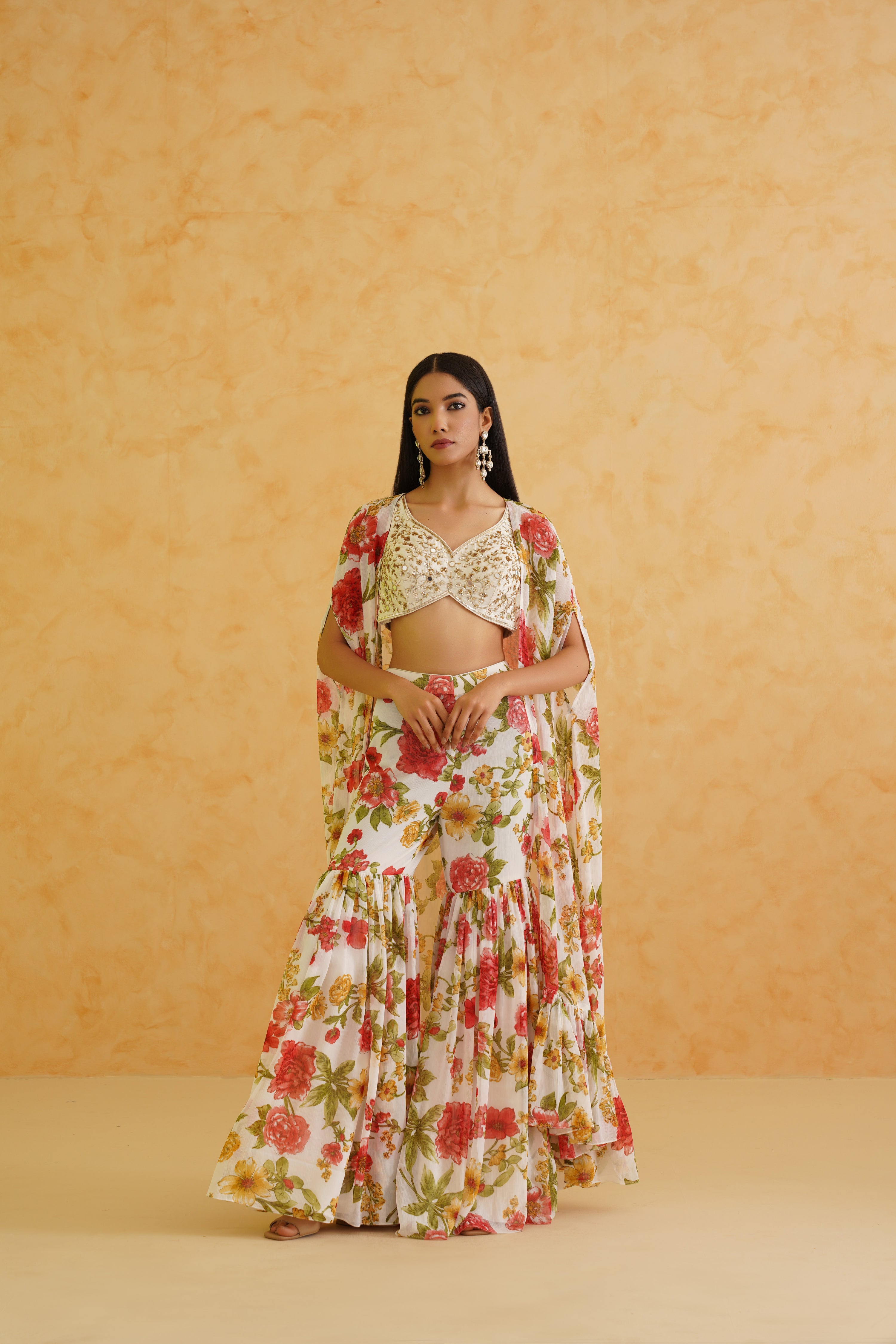 Elegant white embroidered crop top and garara set adorned with intricate crystal, sequins, and zari embroidery for a luxurious look.