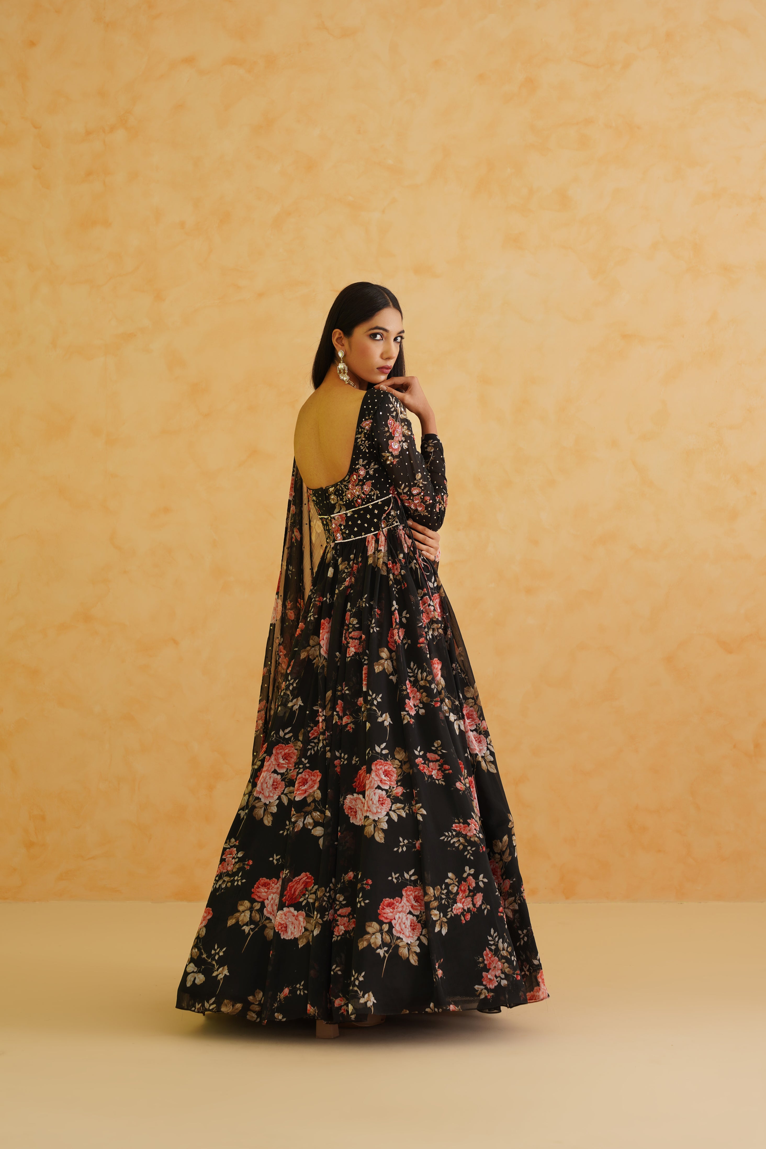 Black printed anarkali suit set featuring a flowing georgette fabric, churidar bottoms, and a coordinated dupatta for a graceful appearance.