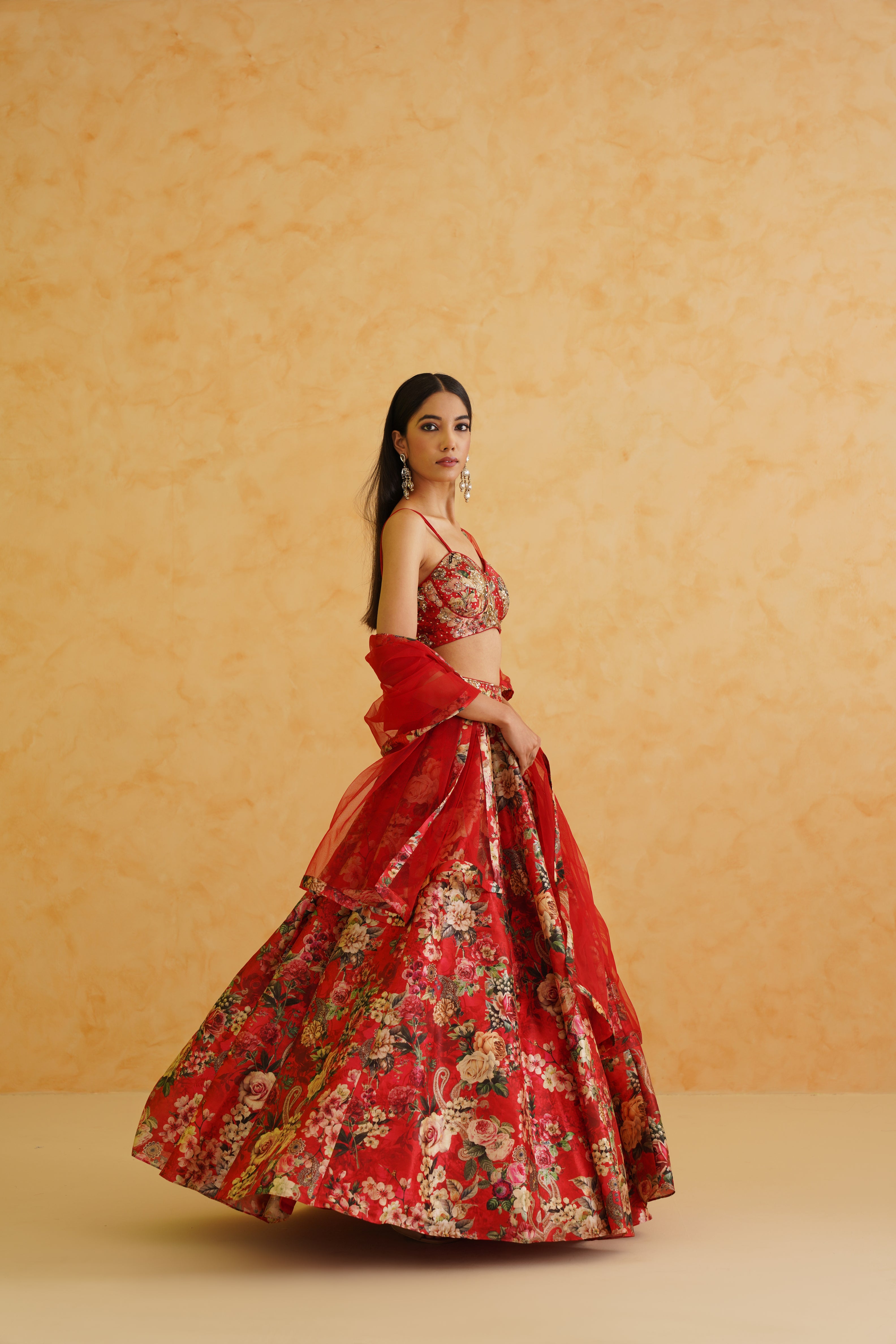 Deepika Chadha's stunning red lehenga set with intricate floral patterns.