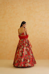 Traditional Indian wedding attire: a red lehenga with gold embroidery and a net dupatta.