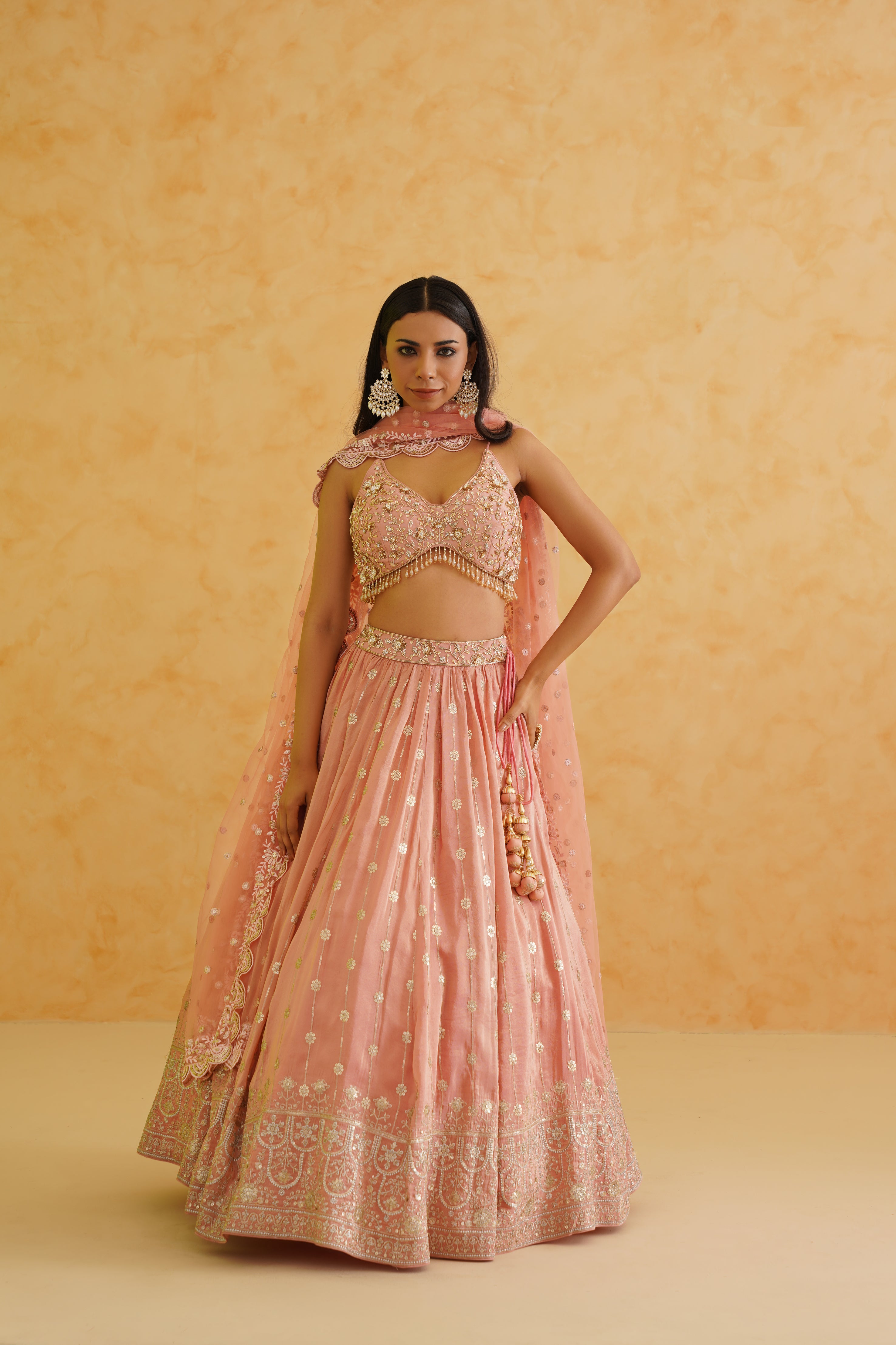 Deepika Chadha's pink georgette lehenga with intricate gold embroidery.