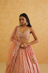 A timeless pink lehenga with intricate gold work for a glamorous look.