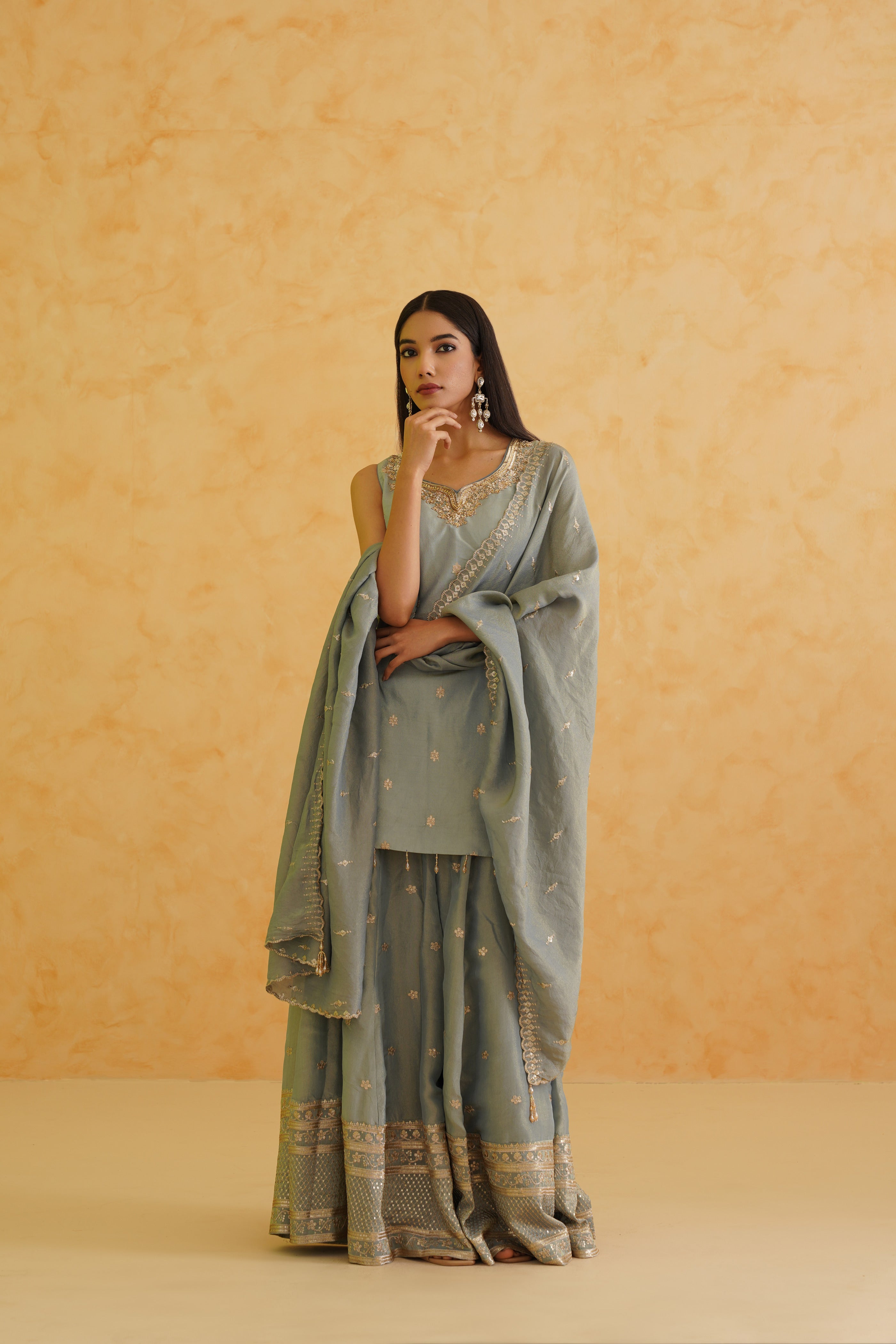 A sophisticated grey sharara ensemble with floral motifs.