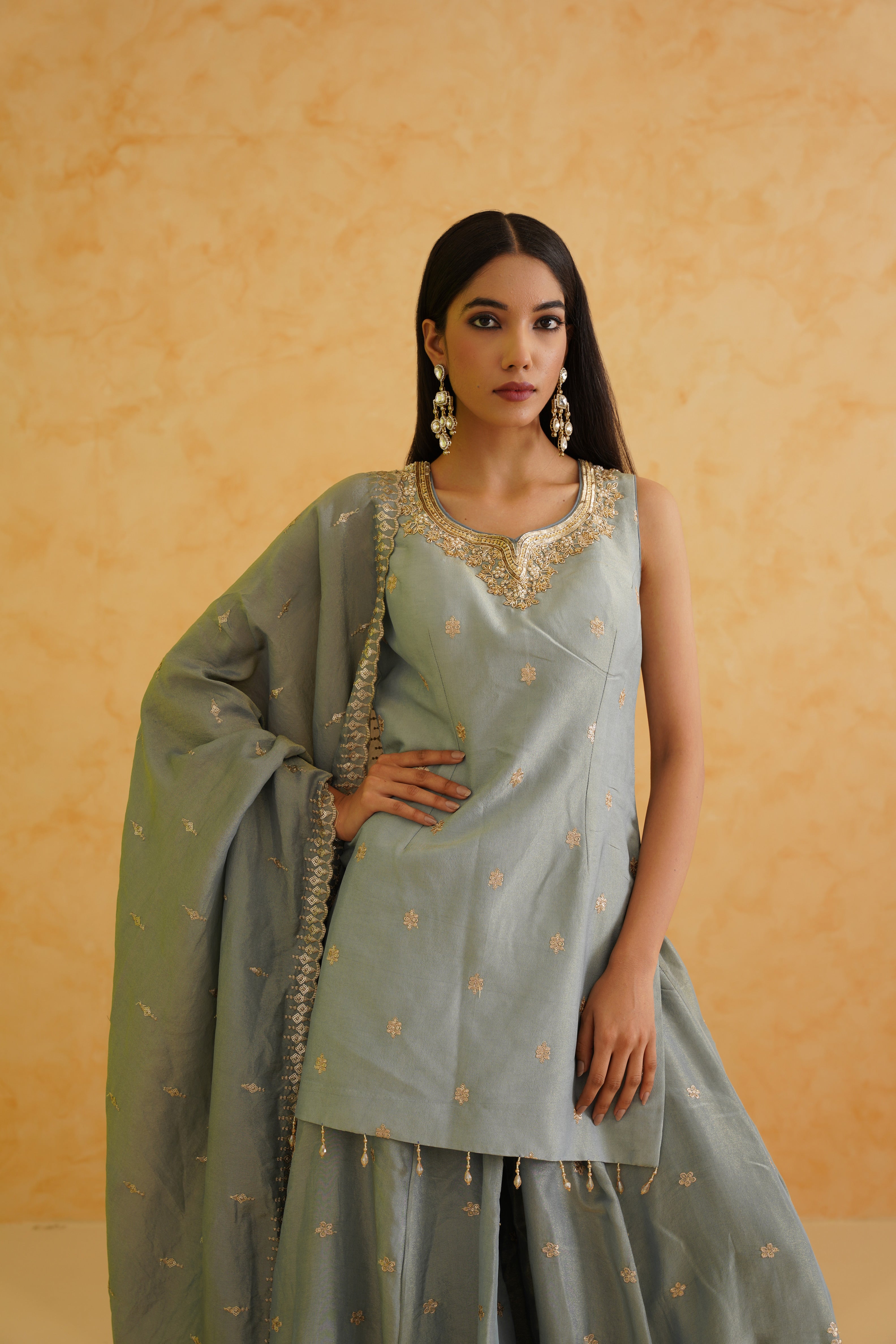 A sophisticated grey sharara with intricate gold work for a glamorous look.