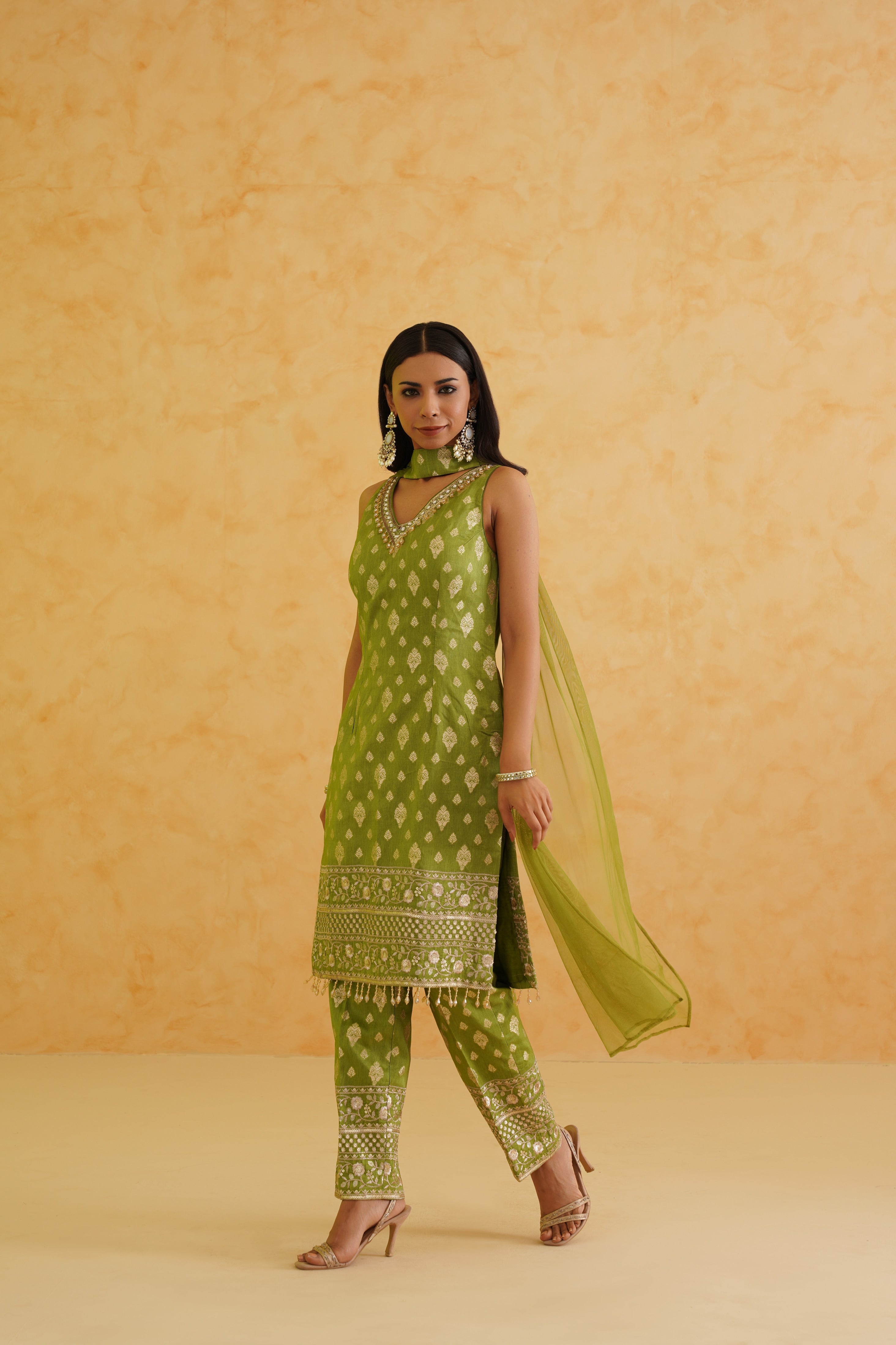 A sophisticated green kurti set with a touch of glamour and elegance.