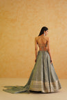 A sophisticated grey georgette lehenga with delicate gold embellishments, offering a timeless and elegant look.