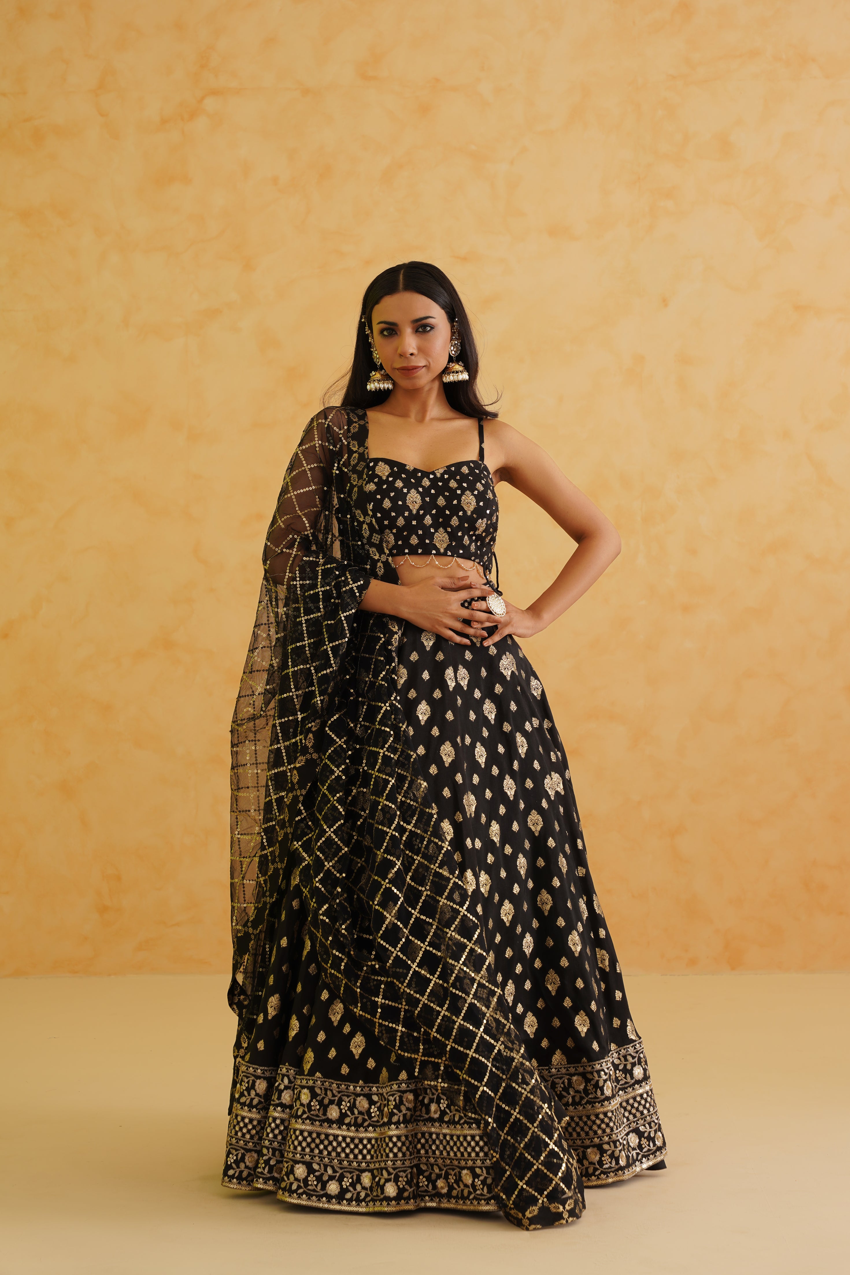 A sophisticated black brocade lehenga set that exudes elegance and style, perfect for any special occasion.