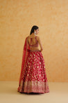 A captivating fuchsia brocade lehenga with a touch of glamour, featuring intricate embroidery and a flowing dupatta.