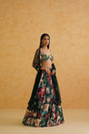 A flowing bottle green georgette lehenga with a vibrant embroidered blouse and a matching net dupatta.