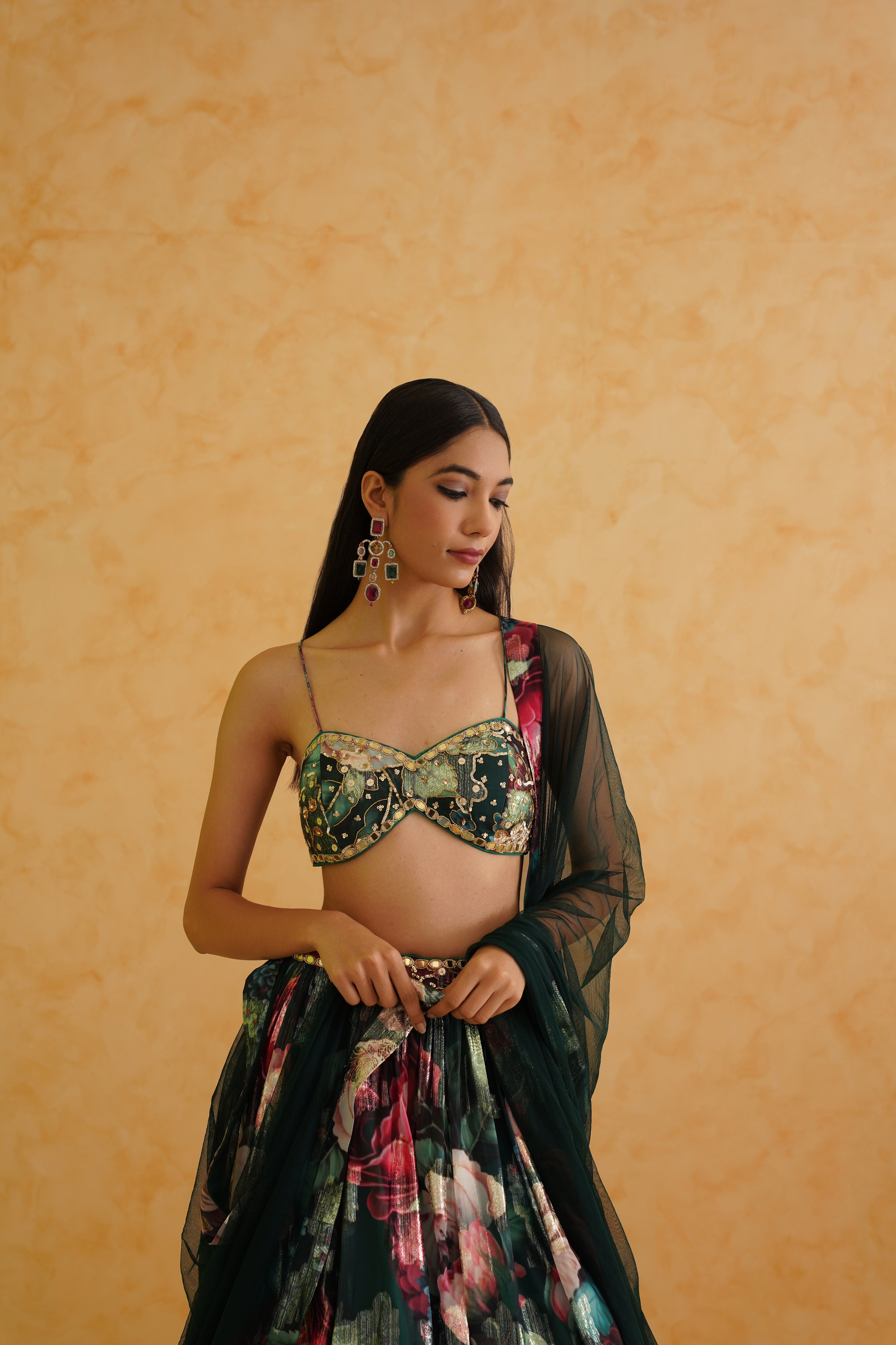 Bottle green georgette lehenga with intricate embroidered blouse and net dupatta.