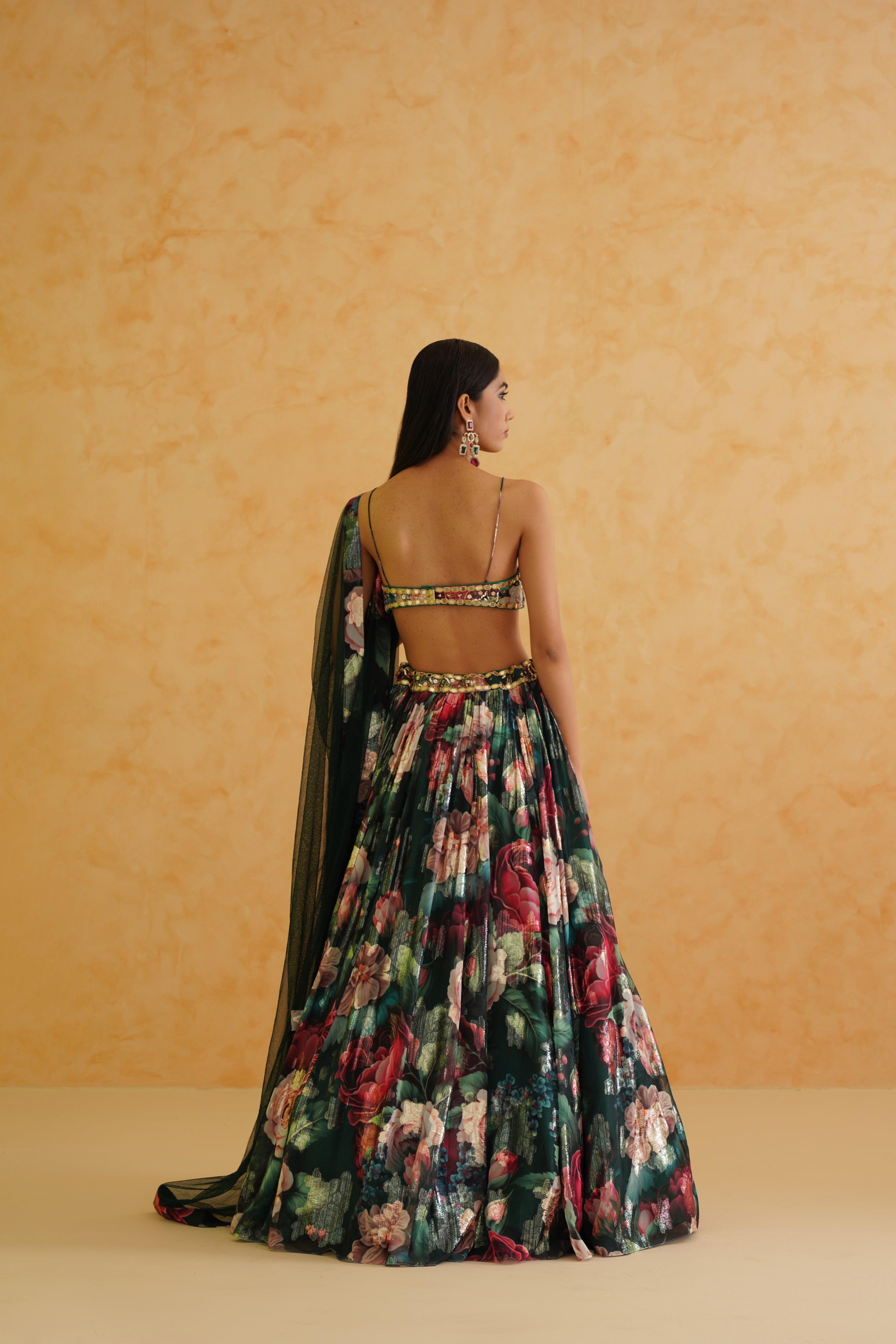 Dazzle in Deepika Chadha's bottle green lehenga, adorned with intricate gold crystal, sequin, and bead embroidery.