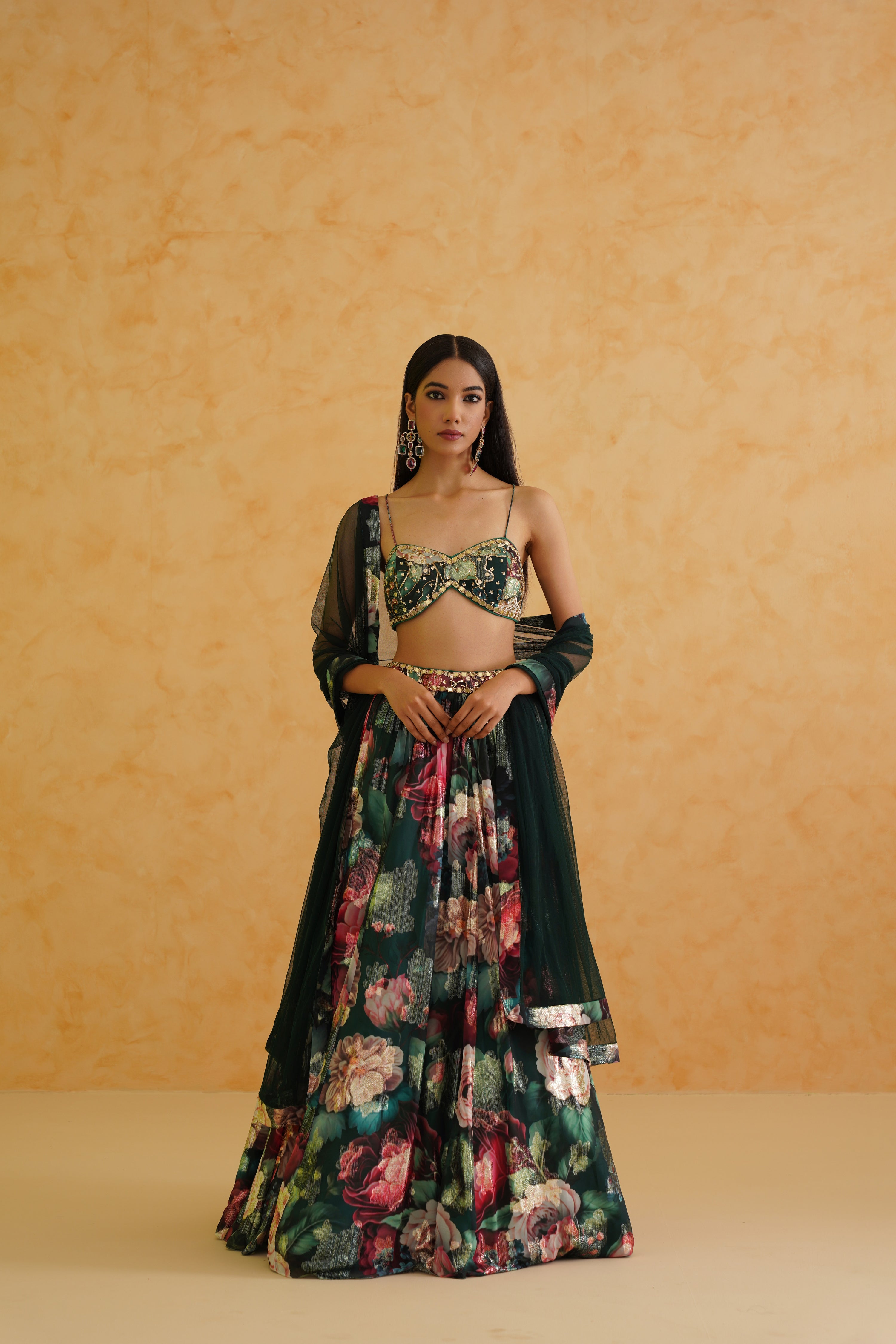 Deepika Chadha's stunning bottle green georgette lehenga features a beautifully embroidered floral blouse with gold crystal, sequins, and beads. 