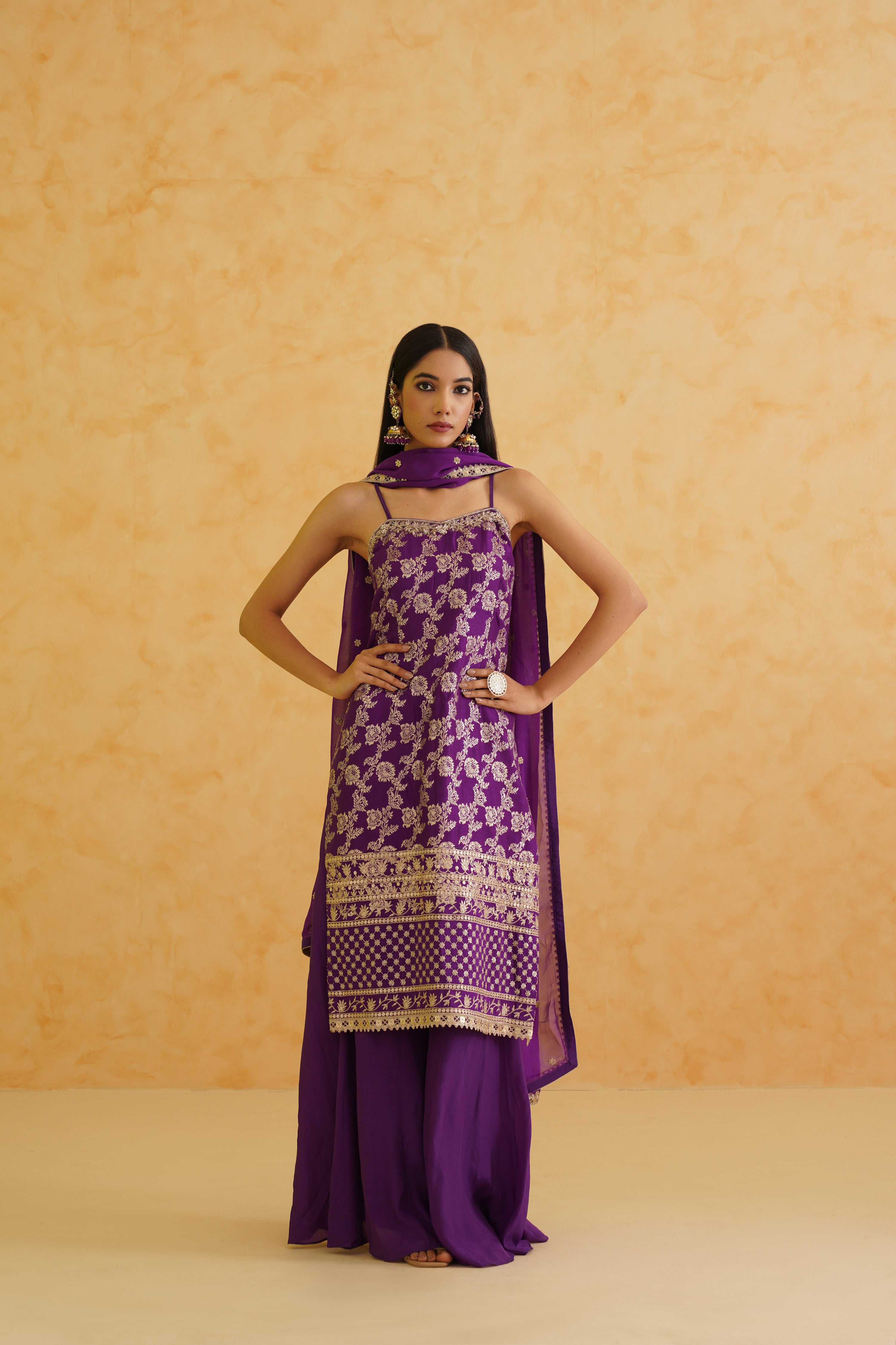 Chic georgette dupatta draping gracefully alongside a beautifully embroidered purple kurti and flowy sharara, perfect for any occasion.