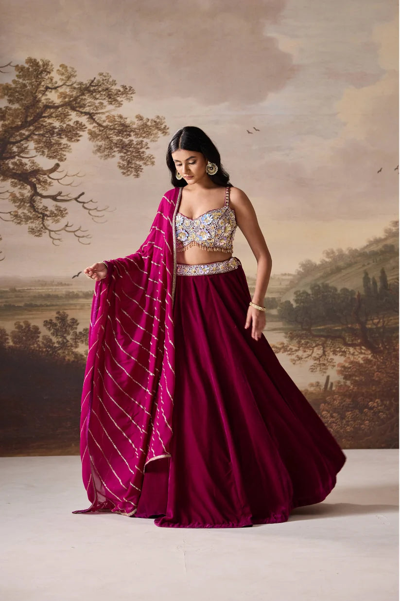Purple embroidered bustier and velvet lehnga set