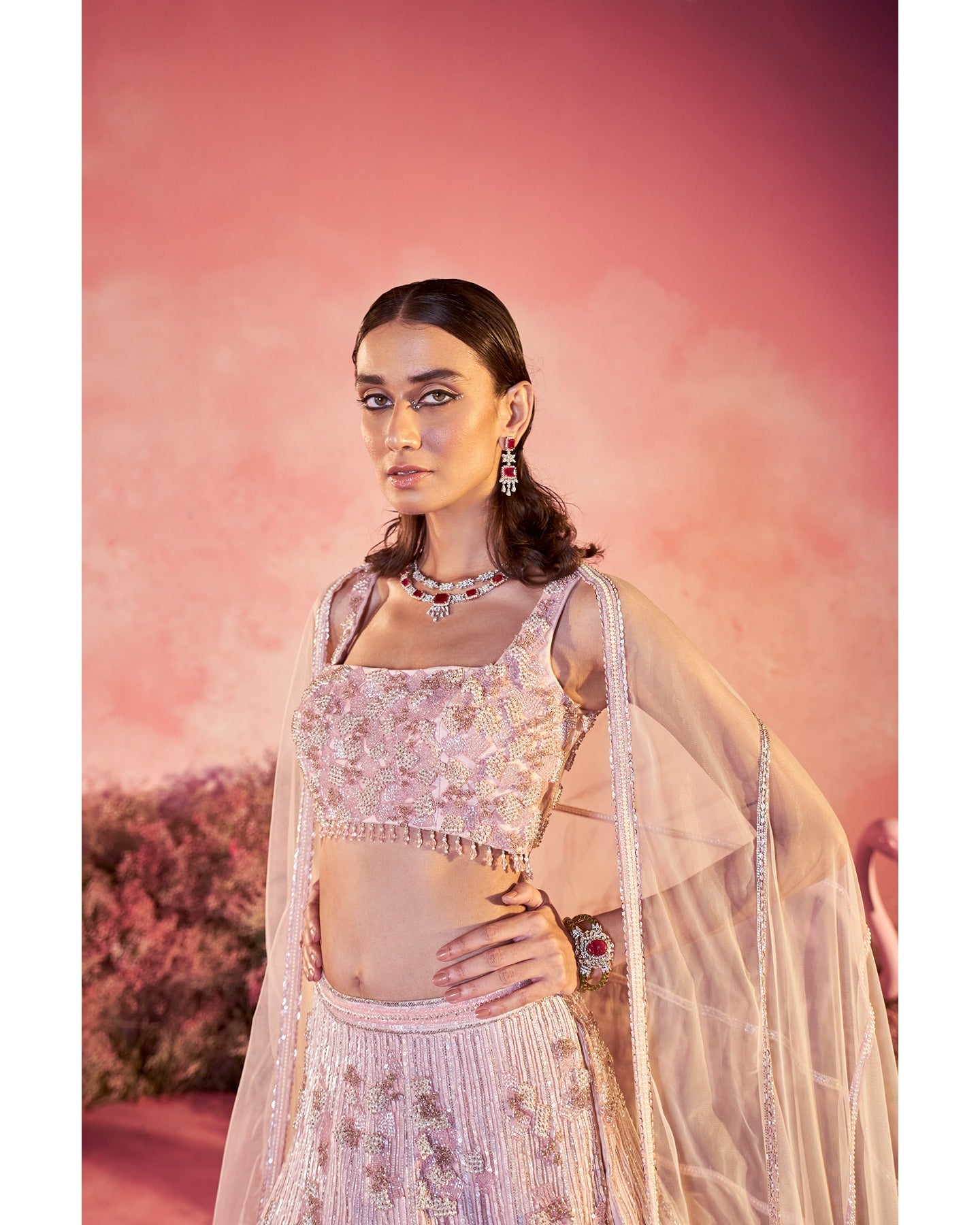 Dream in pink: Embracing the beauty of hand-embroidered details on this enchanting lehenga. 