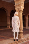 Full view of a sherwani paired with a kurta, pants, and a stole, all enhanced with vibrant embroidery and intricate detailing.