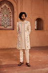 A beautifully crafted open sherwani with intricate hand-painted floral motifs, highlighted by delicate dabka, zardozi, and cutdana embellishments. 