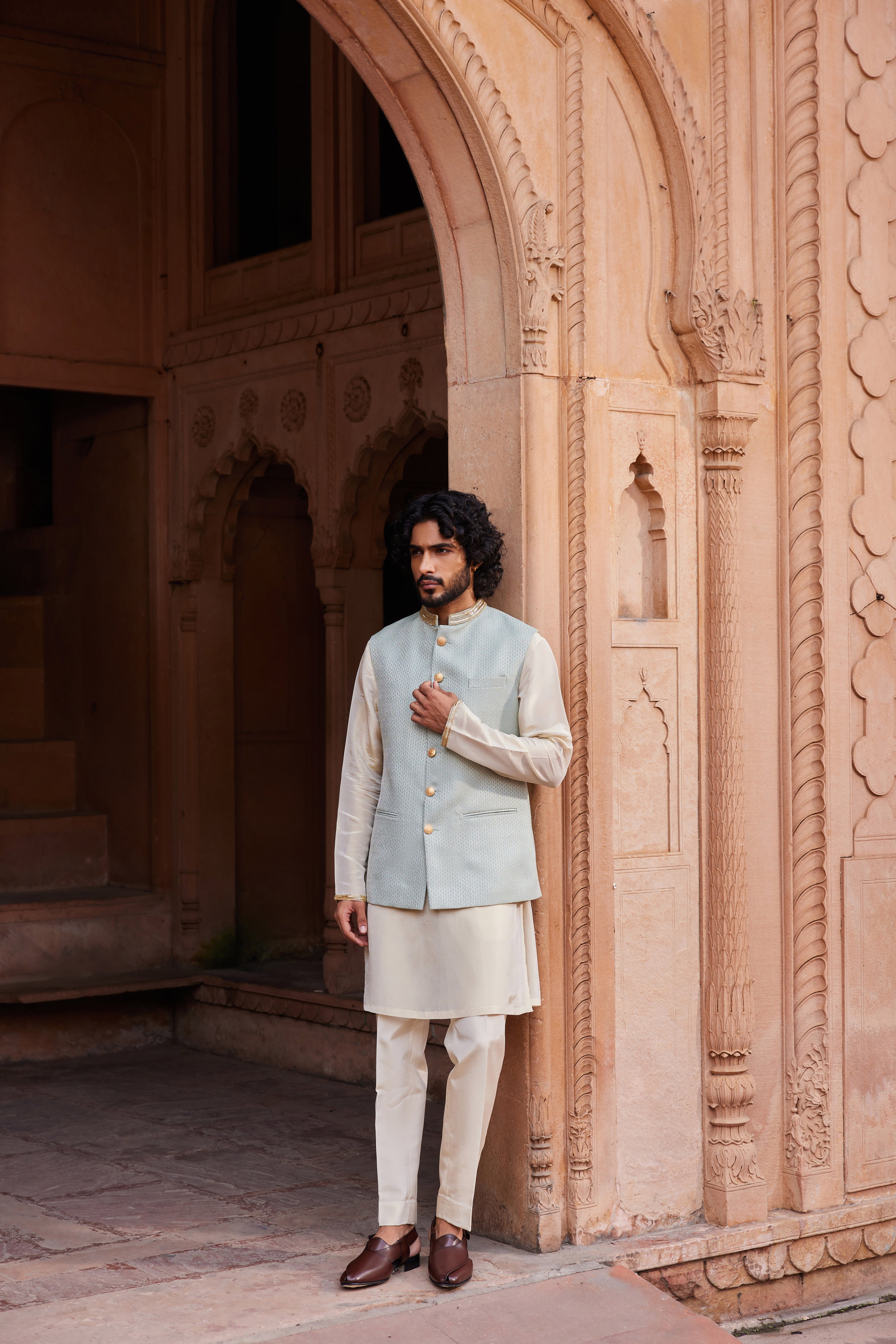  A Nehru jacket with an embroidered collar, paired with a beige kurta and pants