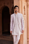 Close-up of a jacket showcasing delicate resham, thread, zardozi, and dabka embroidery with floral motifs, complemented by a detailed kurta and pants.