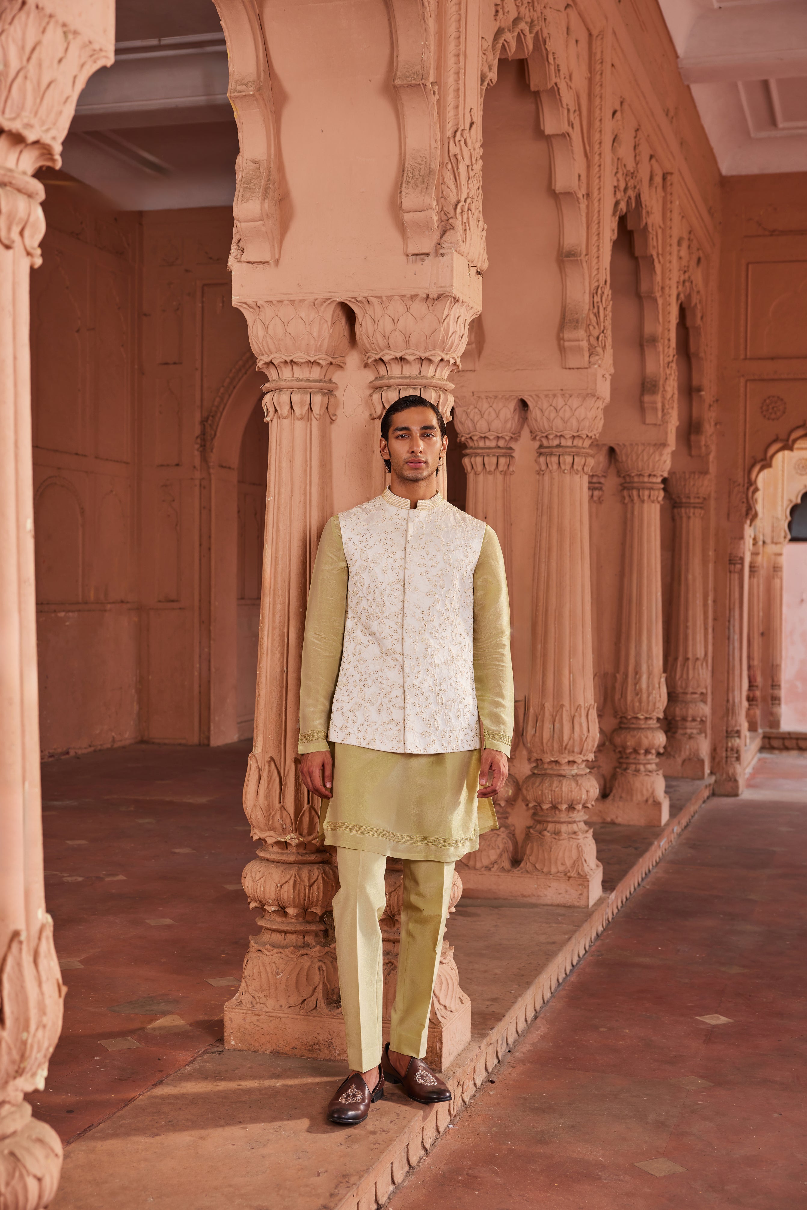 A Jannat Nehru Jacket Set featuring a textured silk jacquard jacket adorned with intricate gold beadwork. Paired with a contrasting detail kurta and matching pants