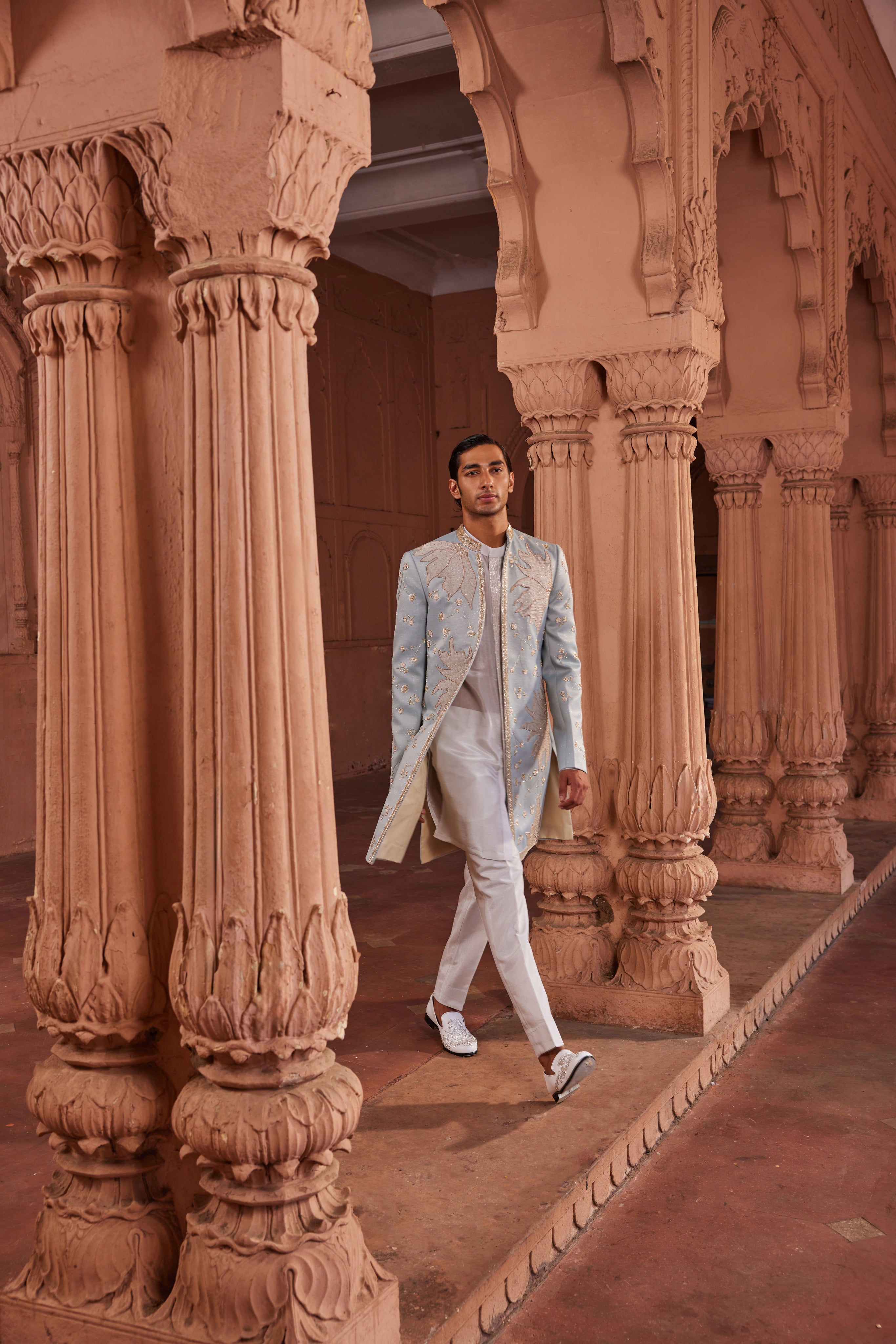 An open sherwani featuring tissue applique mixed with zardozi, dabka, and floral motifs, paired with a front-open kurta with fine placket details and matching pants.