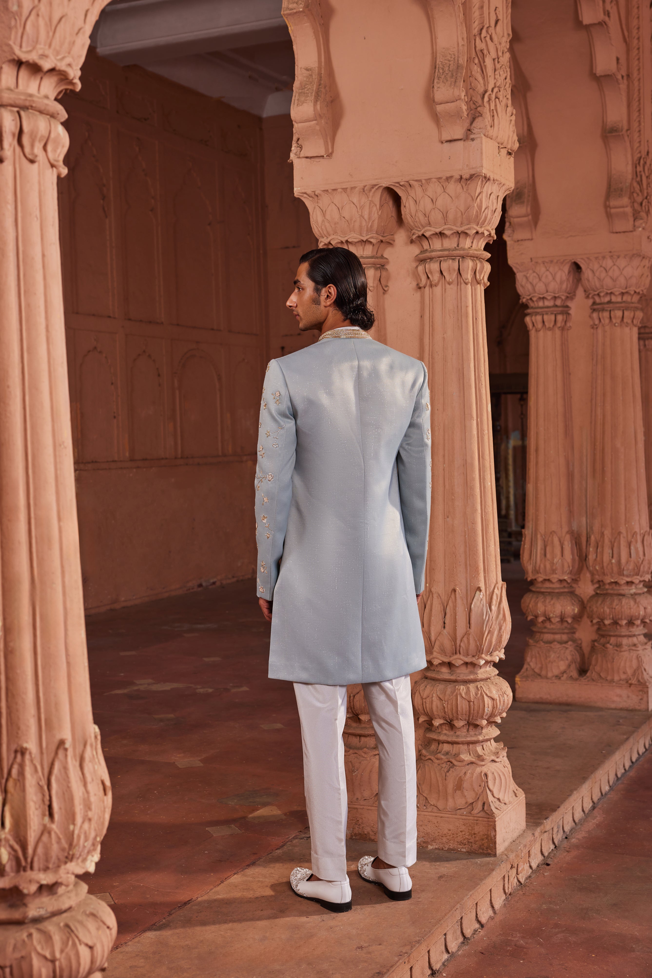 A striking open sherwani showcasing a blend of tissue applique, zardozi, dabka, and intricate floral motifs.