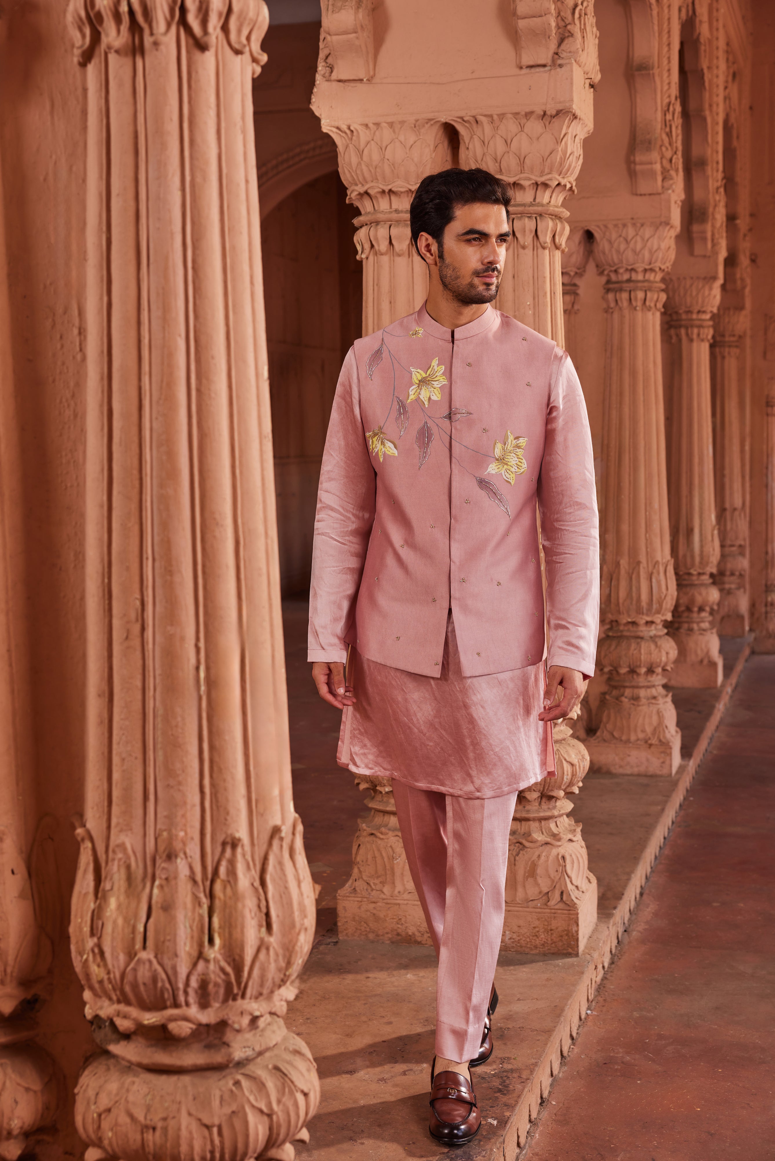 A Husn Nehru Jacket Set featuring a jacket adorned with beautifully hand-painted motifs, accented with intricate dabka and zardozi embroidery. Paired with a monotone kurta and matching pants