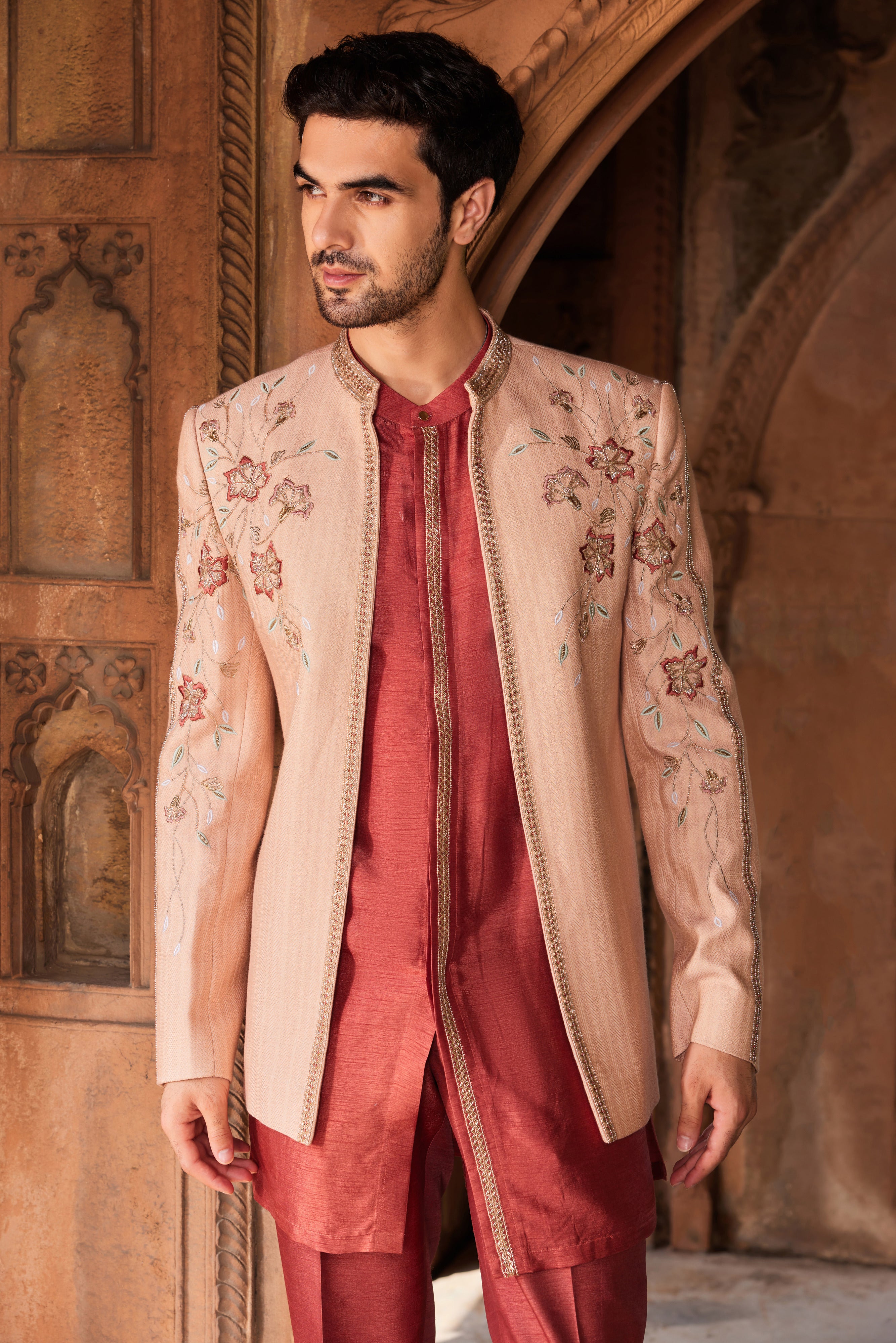 A subtle jacket set featuring intricate floral embroidery, highlighted with delicate cutdana, dabka, and zardozi work, paired with a contrasting kurta and pants for a refined, elegant look