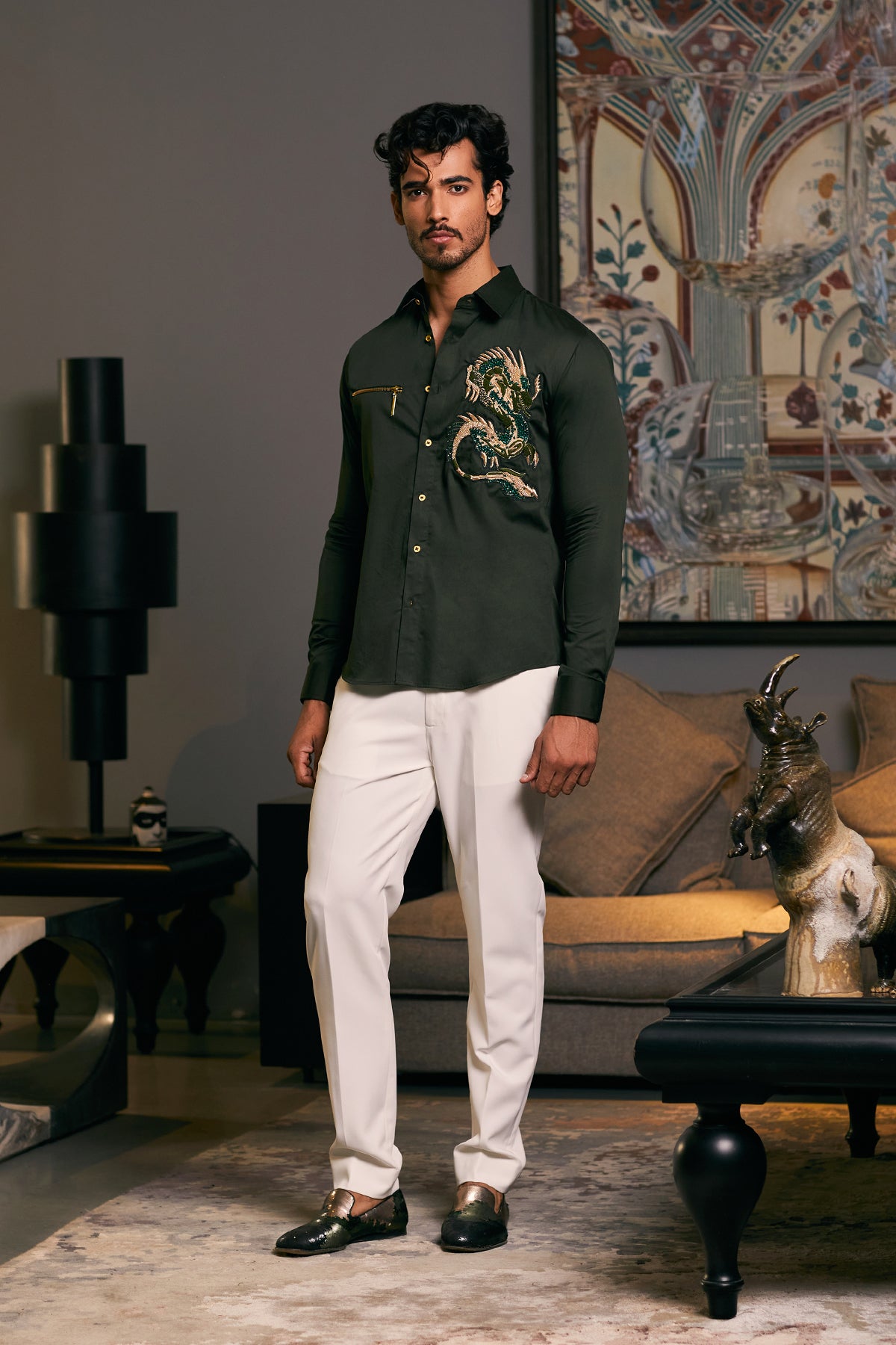 Olive-colored cotton satin shirt with an intricate embroidered dragon and zipper detail. 