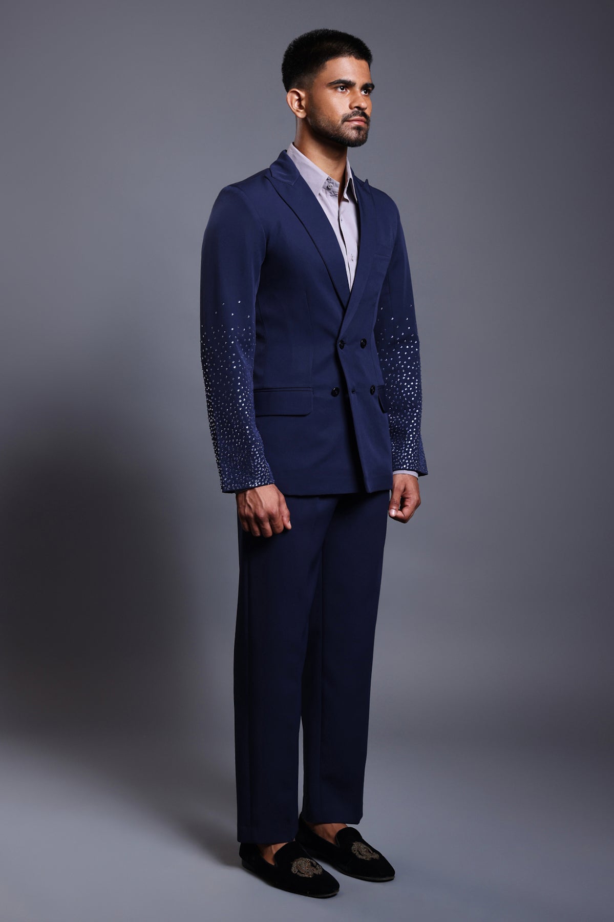 Navy knit suit with gradient self-embedded crystals on the sleeves, blending classic tailoring with modern elegance