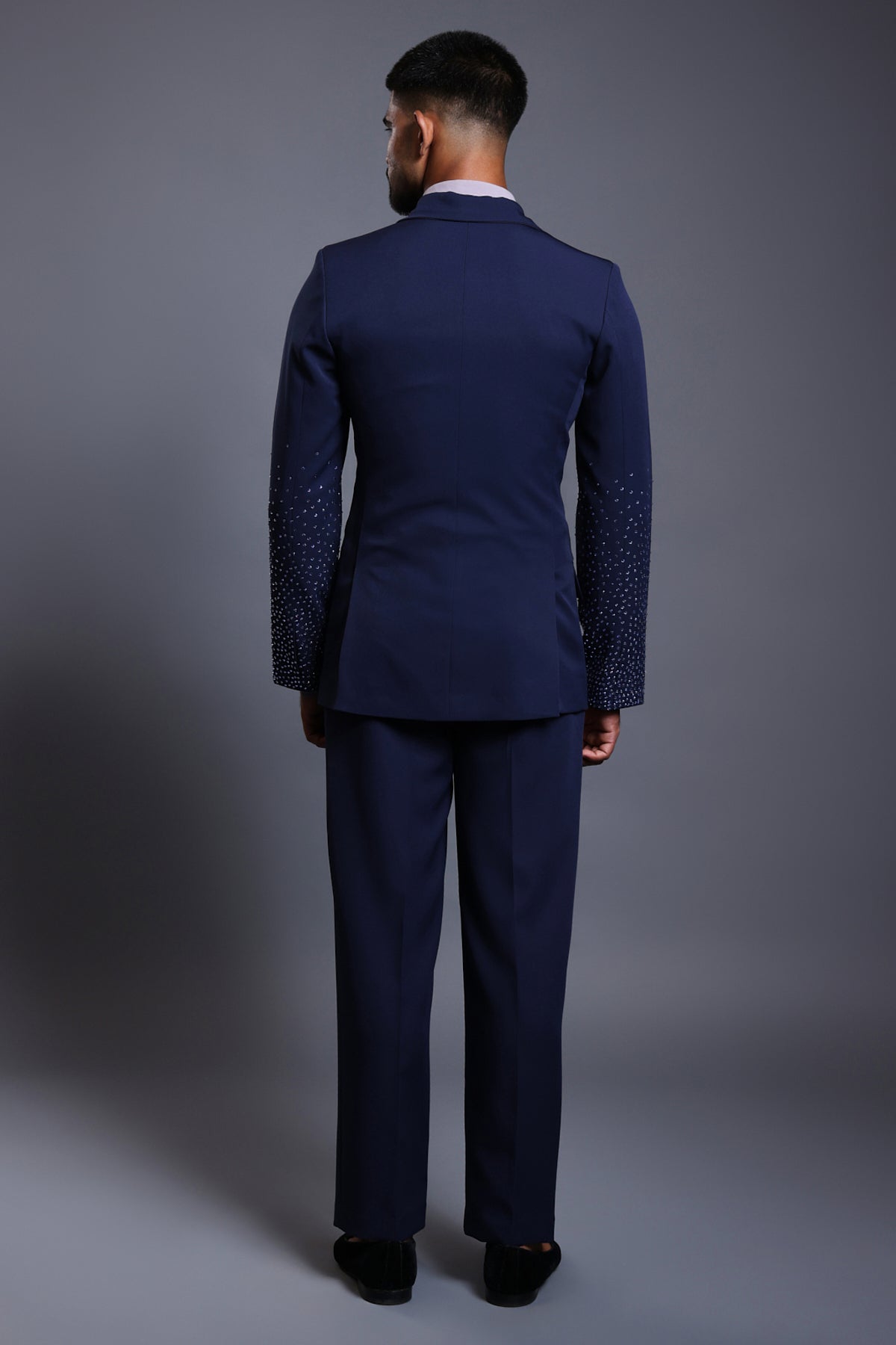 Navy knit suit with gradient self-embedded crystals on the sleeves, blending classic tailoring with modern elegance