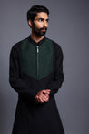 Contemporary black draped kurta with emerald stripwork, crystal rope yoke, and draped dhoti pants, blending modern design with traditional style