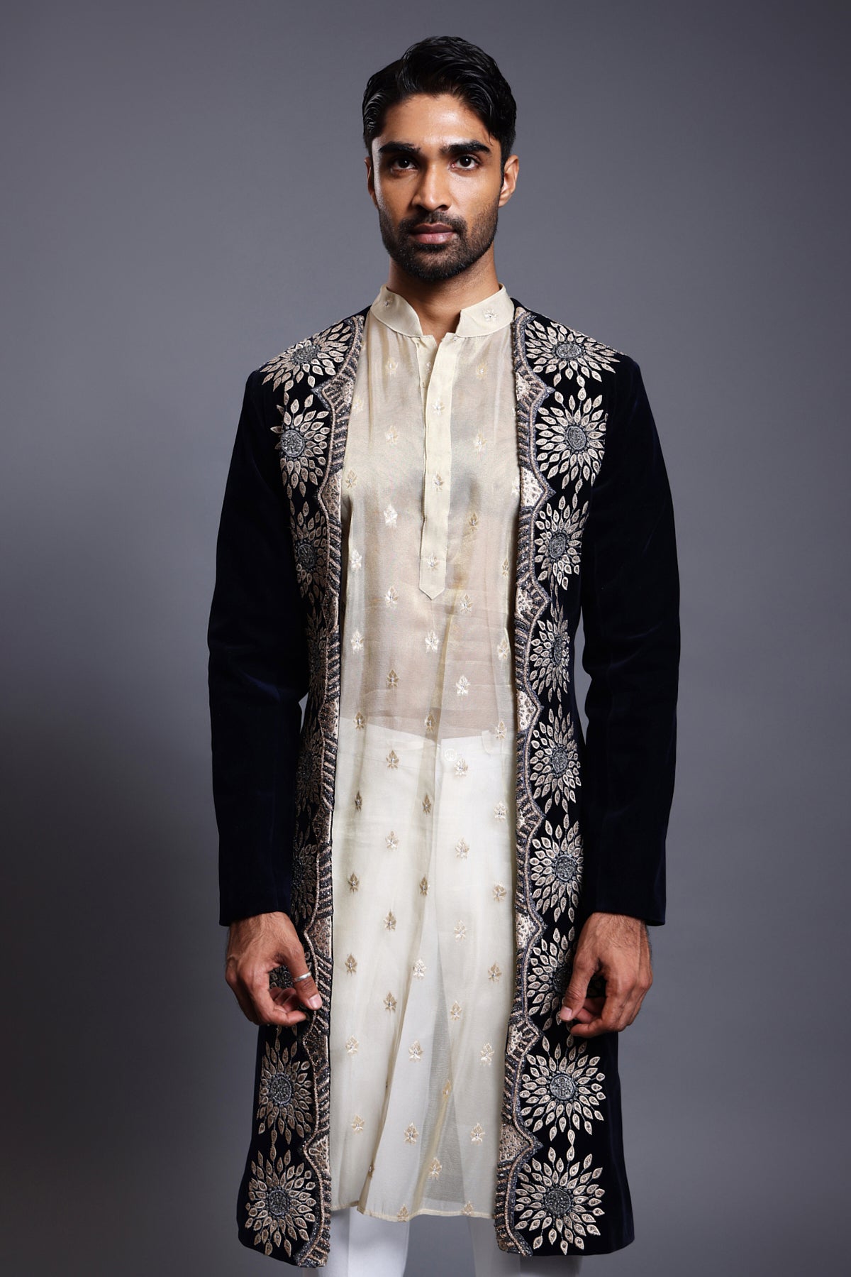 Opulent navy velvet open sherwani featuring detailed applique and sparkling crystal, zircon, and rope embroidery