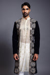 Opulent navy velvet open sherwani featuring detailed applique and sparkling crystal, zircon, and rope embroidery