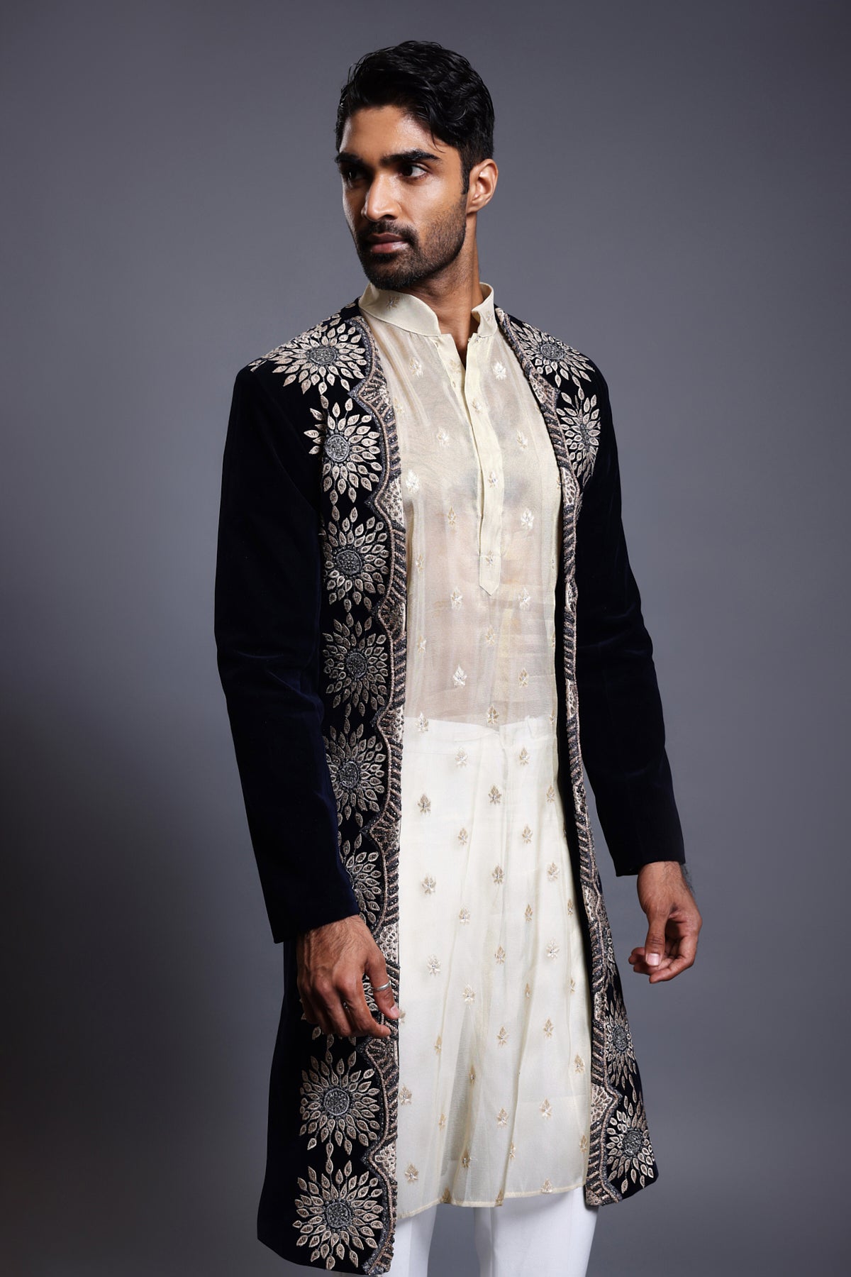 Luxurious navy velvet sherwani with rich applique and crystal embellishments, highlighted by unique crystal rope embroidery