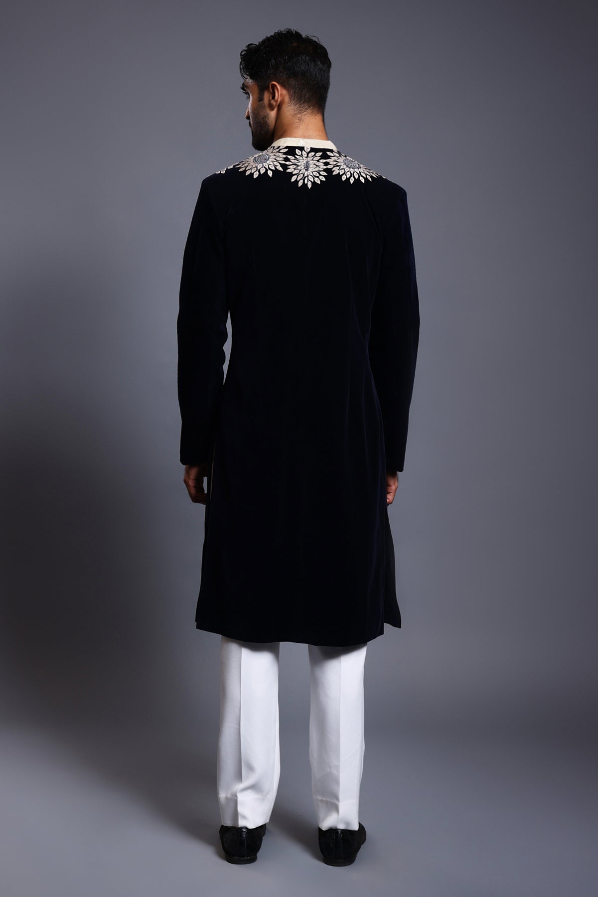 Luxurious navy velvet sherwani with rich applique and crystal embellishments, highlighted by unique crystal rope embroidery