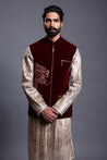 Maroon velvet bandi adorned with crystal and zari flower motifs for a luxurious and elegant look.