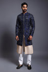 Navy silk sherwani with crystal, beads, and zircon embroidery, paired with a stripwork sherwani kurta for a luxurious and modern look.