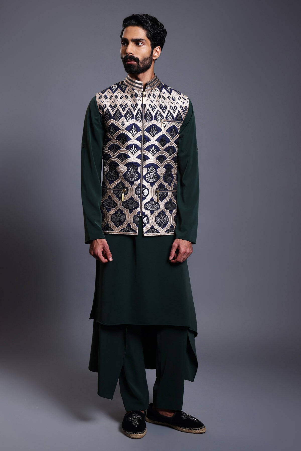 Navy silk bandi with gold and gunmetal applique work paired with an emerald microfiber draped kurta and pants, blending traditional elegance with modern style