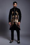 Black velvet sherwani with intricately embroidered phoenix birds in mixed media, showcasing luxurious craftsmanship.