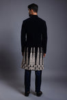 Sophisticated navy velvet sherwani with detailed floral applique and subtle crystal accents on the hem, exuding elegance and refinement for special occasions