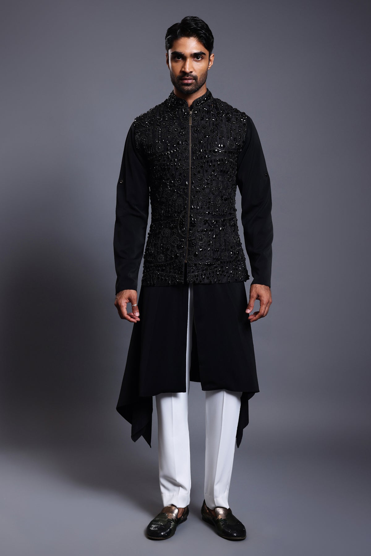 Black silk waistcoat with crystal, beads, and zircon embroidery, paired with a draped kurta set for a sophisticated and elegant look.