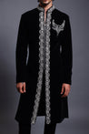 Sophisticated black sherwani in velvet, embellished with a crystal border and necklace crest