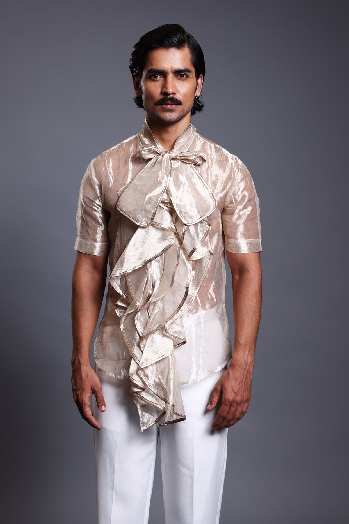 Gold cascade tissue shirt with a stylish bow, showcasing a flowing and elegant design