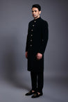 Elegant navy velvet sherwani adorned with gold buttons, perfect for formal occasions.