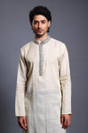 Elegant ivory and gold chanderi kurta with shimmering crystals on the collar and placket, perfect for formal occasions.