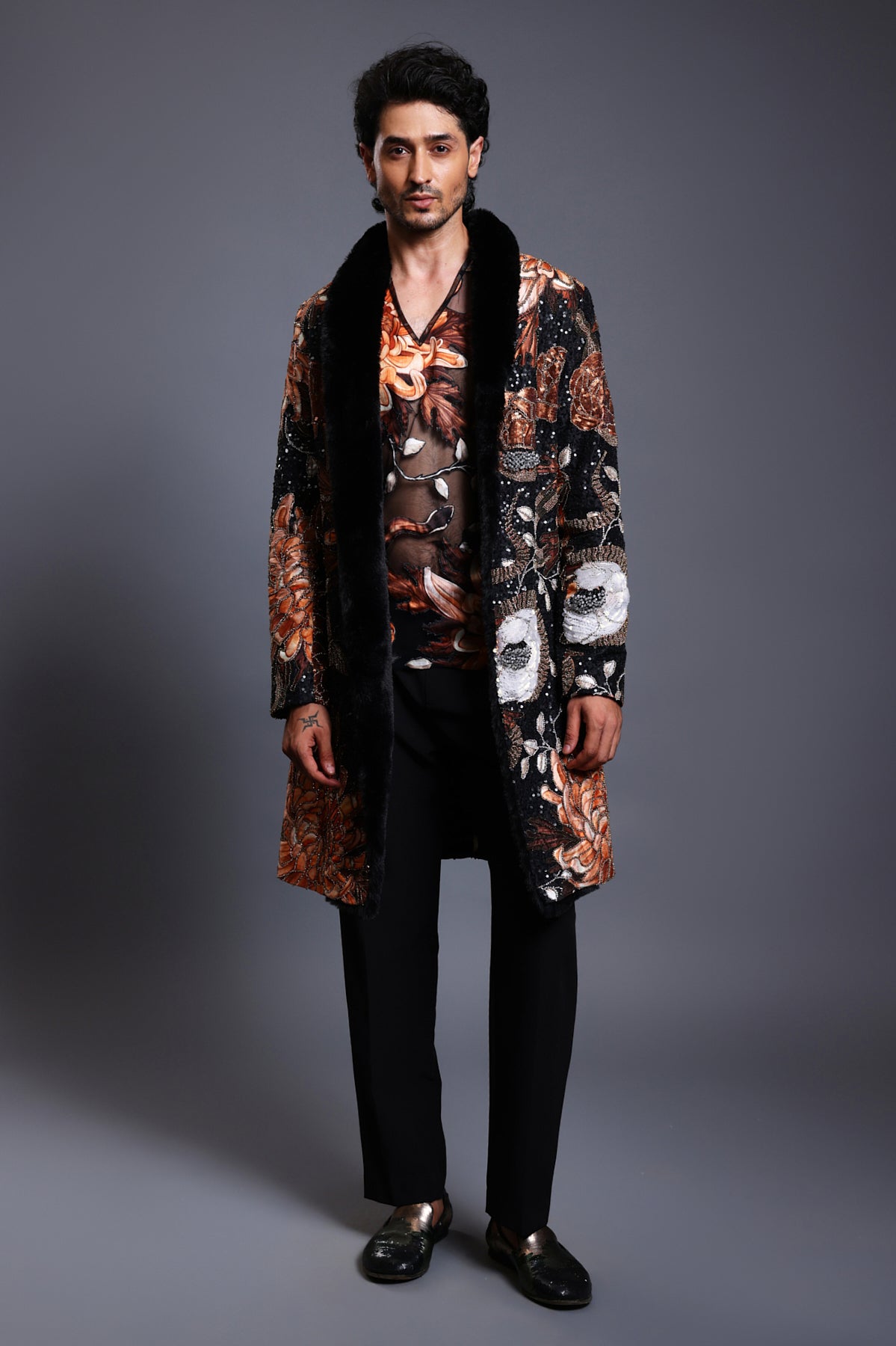 Black overcoat with a striking snake print, featuring mixed media embroidery and a plush faux fur collar.