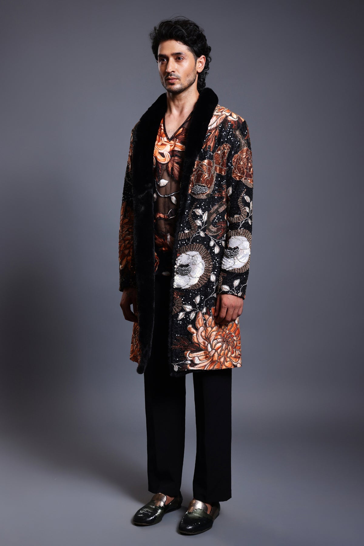 Black overcoat with a striking snake print, featuring mixed media embroidery and a plush faux fur collar.